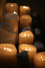 Burning candles on a nice table in the dark