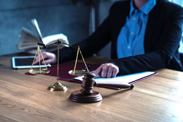 lawyer judge reading documents at desk in courtroom