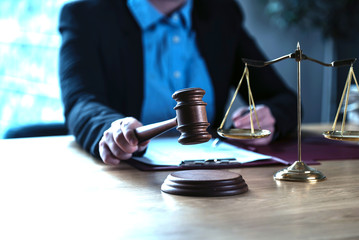 lawyer judge reading documents at desk in courtroom