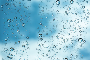 Rain on the window, natural skin of the rain The natural form of rainwater on a sky background.