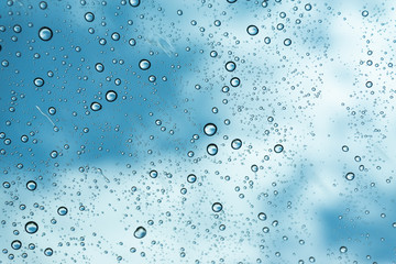 Rain on the window, natural skin of the rain The natural form of rainwater on a sky background.