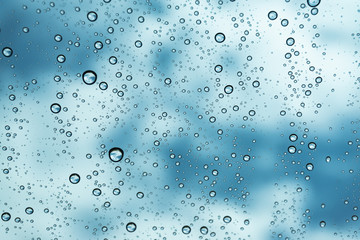 Rain on the window, natural skin of the rain The natural form of rainwater on a sky background.