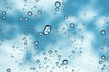 Rain on the window, natural skin of the rain The natural form of rainwater on a sky background.