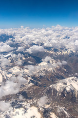 Fototapeta premium Bird eye view of snow mountains and sky cloud from window of airplane at Leh, India