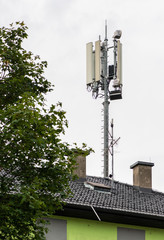 5G antennas on top of house. Antennas and transmitters on roof.