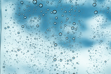 Rain on the window, natural skin of the rain The natural form of rainwater on a sky background.