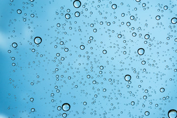 Rain on the window, natural skin of the rain The natural form of rainwater on a sky background.