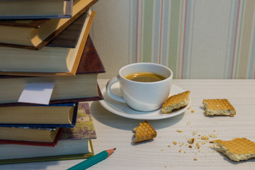 Espresso Cup with cookies and books on the white table