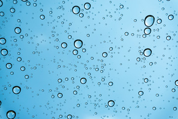 Rain on the window, natural skin of the rain The natural form of rainwater on a sky background.