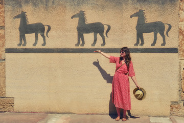 Tourist shows drawings of ancient horses on the wall of Carthage-archaeological Museum in Tunisia....