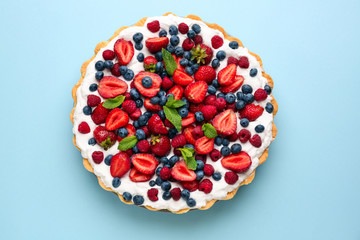 Tasty berry pie on color background