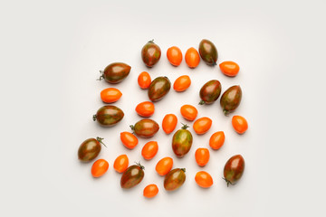 Different fresh tomatoes on light background