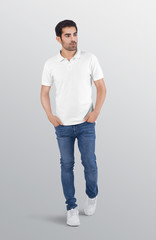 Male model wearing white plain polo t shirt in blue denim jeans pant. Isolated background