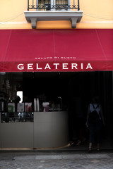 Italian ice cream shop. Text gelateria on sunshade.