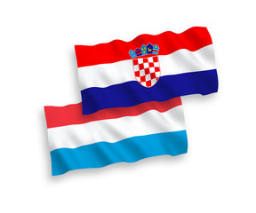 National vector fabric wave flags of Croatia and Luxembourg isolated on white background. 1 to 2 proportion.