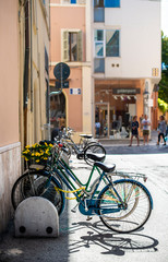Fototapeta na wymiar Bikes mounted on a bicycle stand on italian street.
