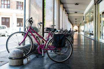 Bikes mounted on a bicycle stand on italian street.