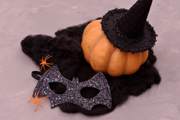 Halloween pumpkin head. Pumpkin head in a bat mask. Halloween decoration with pumpkins and accessories.