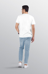 Fototapeta na wymiar Back view of standing male model wearing white plain crew neck t shirt in ripped blue denim jeans pant. Isolated background.