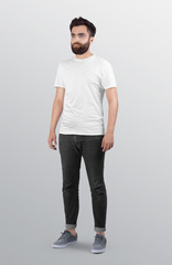 Standing Male model wearing white plain crew neck t shirt in dark grey denim pant. Isolated background.