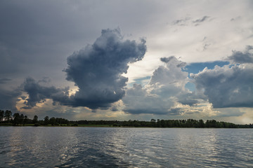 Naklejka na ściany i meble Heavy storm clouds over the lake