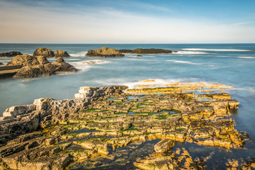 Northern Ireland Antrim Coast Ballintoy Harbour long exposure rocks sunset waves beautiful scenery