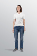 Fototapeta na wymiar Woman model wearing white plain v neck t shirt in blue denim jeans pant
