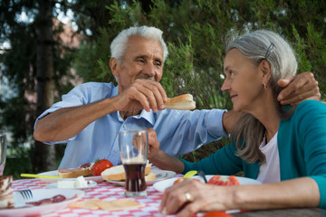 Man feeding woman with a sandwich