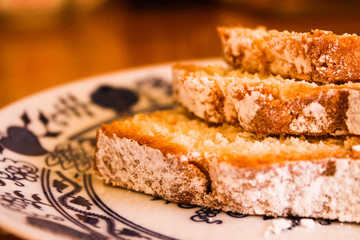 Delicious cheesecake sprinkled with powdered sugar. Sponge cake texture. Close up. Tasty appetizing photo.