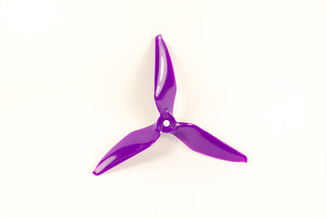 Closeup of quadcopter or drone propeler for freestyle or racing drone. 5051 3 blade propellers in purple taken in high key with bokeh effect