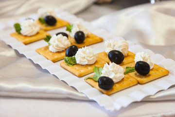 Snacks with Olives and Cream on Cookies