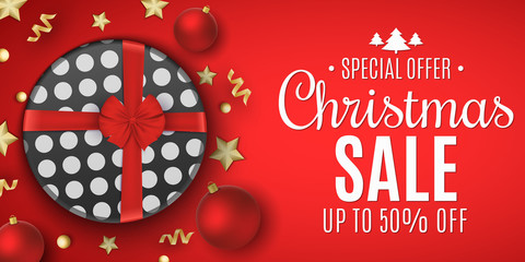 Naklejka premium Banner for Christmas sale. Gift box with a red bow. Balls with golden stars and serpentine. Stylish lettering. Seasonal holiday shopping. Vector illustration