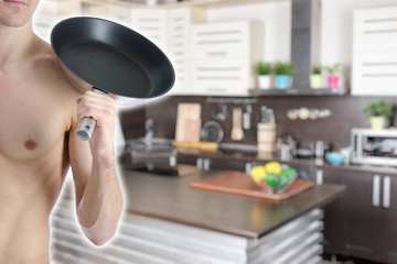 Young attractive guy in the kitchen.