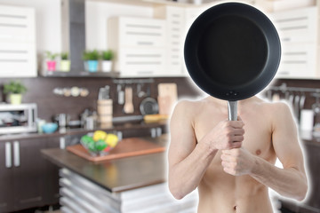 Young attractive guy in the kitchen.