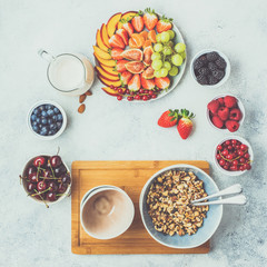Toned photo of paleo granola or muesli made from nuts. Fruit berries platter, strawberries blueberries raspberries peach figs, toned, top view, selective focus