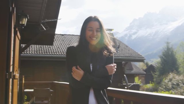 happy beautiful woman at a ski chalet chalet in Chamonix France slowmotion