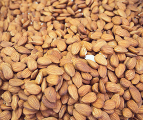 Peeled almond nuts at the market close up. Selective focus. Healthy food concept background
