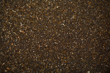 Detailed view of black sand, shallow depth