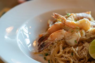 Spicy Spaghetti shrimp, italian food, white plate.