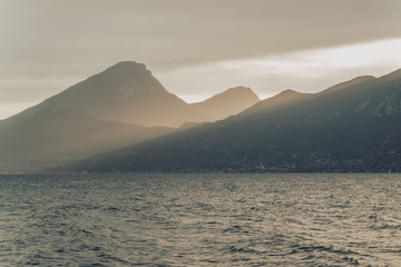 Flare of light after storm at mountain lake