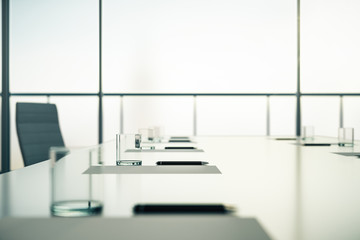 Close up of conference table ready for business meeting with glasses, pen and blank sheet in the...