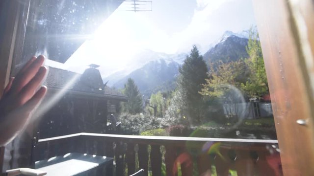 woman at a ski chalet admire mountains window in Chamonix France slowmotion