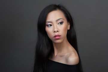 Studio portrait of young asian woman