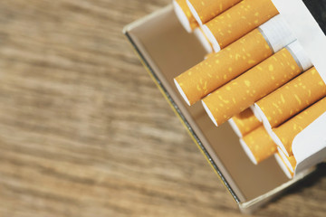 peel it off Cigarette pack prepare smoking a cigarette on the wooden. Packing line up. photo filters Natural light. soft focus. Leave space to write a description of the message.