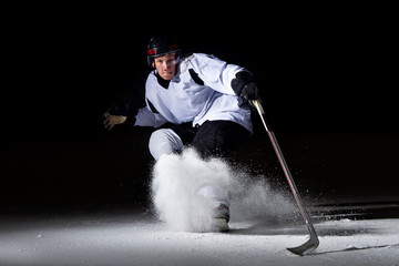 ice hockey player in action kicking with stick © Augustas Cetkauskas