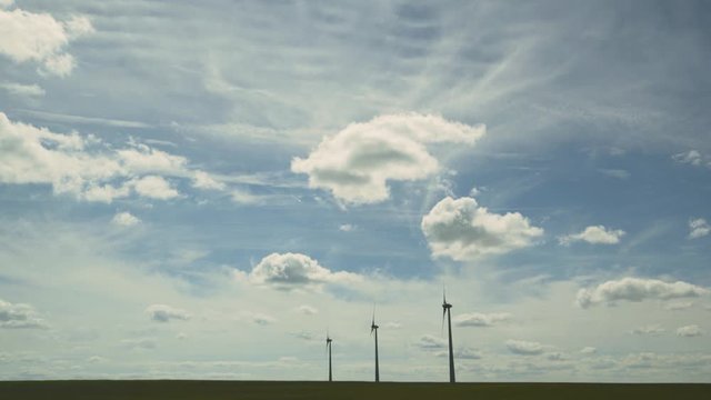 Wind turbines and agricultural fields on a summer day - Energy Production with clean and Renewable Energy