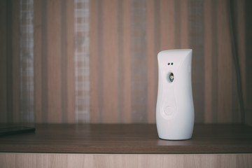 Automatic white air freshener on the chest of the house