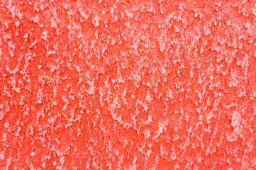 Rough texture of abstract decorative red background of plaster wall.