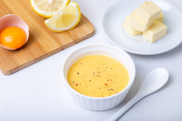Homemade Hollandaise Sauce. Classic traditional sauce based on eggs. Basic sauce of French cuisine. Selective focus, close-up.