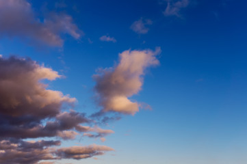 blue sky background with dark fluffy clouds